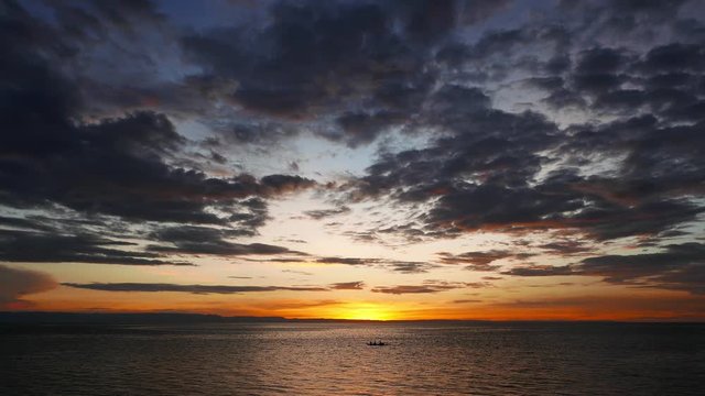 A colorful sunset video from Camotes Island shores. Local fishermen can be seen in the distance going back home (in silhouette form). Presented in real time.