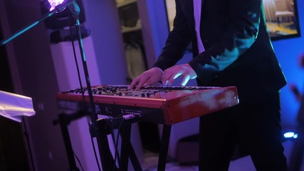 hands of musician playing keyboard in concert with shallow depth of field - Powered by Adobe