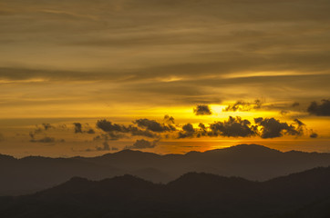 Landscape with sunset at the seashore over mountain range

