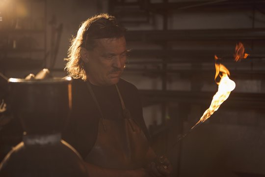 Blacksmith holding a welding pipe