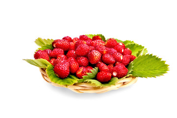 Strawberries with leaves on wicker tray