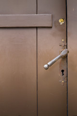 Old church brown door with lock and handle