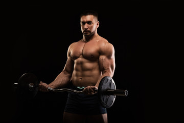 handsome muscular bodybuilder posing on a black background