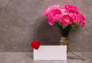 Fresh pink carnation flower and blank card 