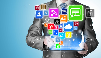 Business man using tablet PC with social media icon set
