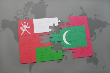 puzzle with the national flag of oman and maldives on a world map background.