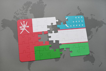puzzle with the national flag of oman and uzbekistan on a world map background.