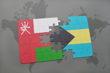 puzzle with the national flag of oman and bahamas on a world map background.