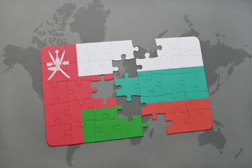 puzzle with the national flag of oman and bulgaria on a world map background.