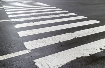 The wet pedestrian crosswalk on city street, safety concept.