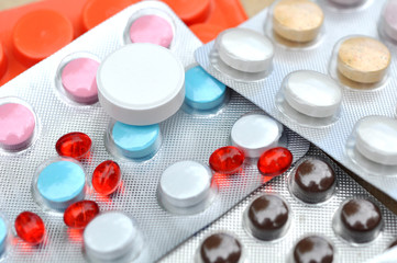 Many Pills, Drugs and Tablets on table as background
