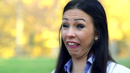 Slowmotion young woman stands and does pulls a face and sticks out one's tongue - Powered by Adobe