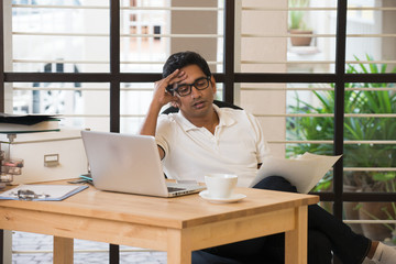 sick looking indian business male at office