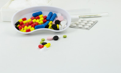 Medicine, pills of different colors on a white background, drugs health
