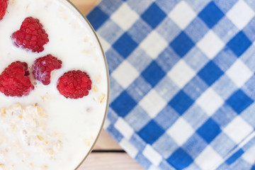 oatmeal with raspberries on a wooden background. breakfast