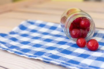 cherry in a glass jar on a napkin
