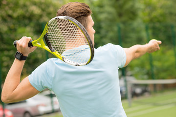 Skillful athlete playing tennis on court