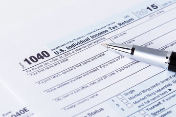 Income tax form and pen