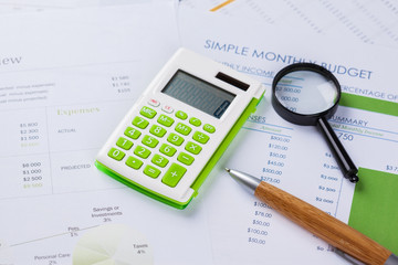work with a magnifying glass, a calculator and papers