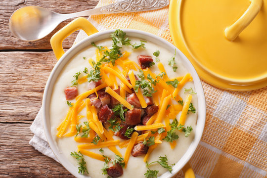 Tasty thick potato soup with bacon and cheddar cheese. horizontal top view
