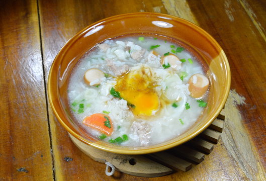 rice porridge with pork sausage topping creamy yolk on bowl