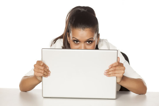 Young Happy Woman Hiding Behind A Laptop