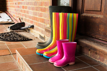Colourful wellington boots left on a doorstep