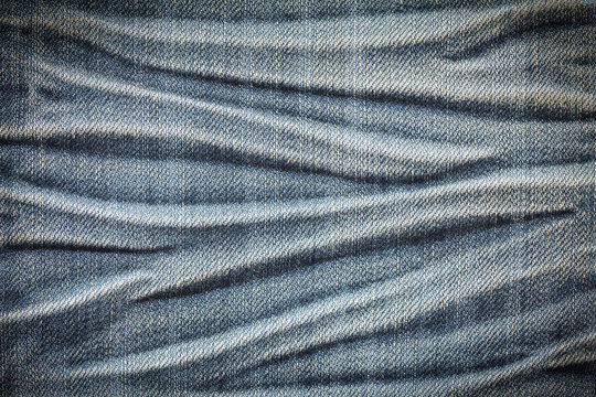 Closeup denim jeans texture or denim jeans background for design with copy space for text or image. Dark edged.