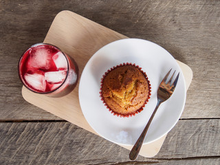 Top view of banana cup cake and grape juice