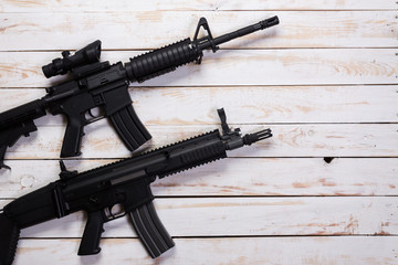 Assault automatic rifle on white wooden table