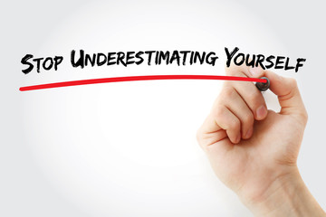 Hand writing Stop Underestimating Yourself with marker, concept background