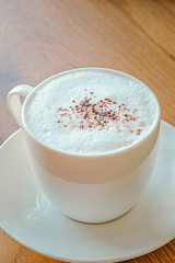 Cappuccino with cinnamon on a decorative background