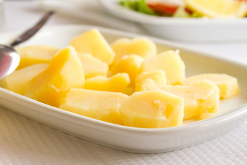 boiled potato on white dish