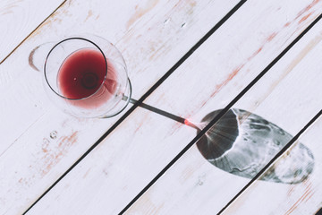 Glass of red wine on wooden table