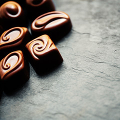Delicious chocolate candies. Chocolates as background. Dark Chocolate Candy. Praline sweets. Low key photo