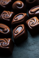 ..Chocolate over black background. Chocolate Candy, Cocoa. Assor