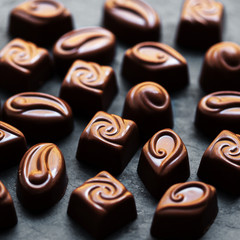 ..Chocolate over black background. Chocolate Candy, Cocoa. Assor