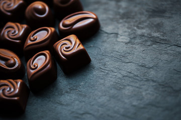 ..Chocolate over black background. Chocolate Candy, Cocoa. Assor