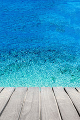 Beach and tropical sea. Blue sea water and wooden terrace.