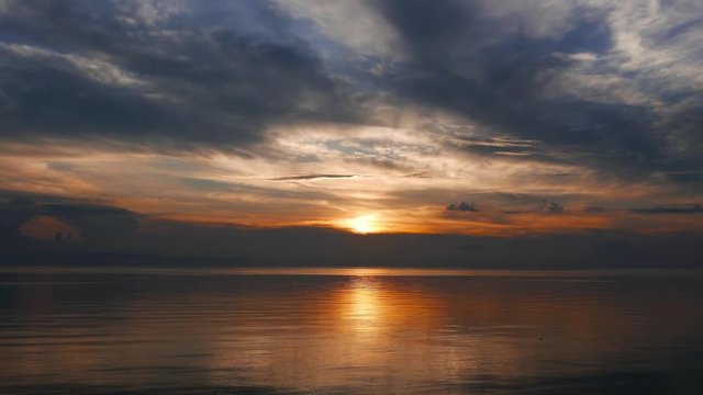 An accelerated, colorful sunset video from Camotes Island. Sun is just over the horizon, behind dark clouds. Presented as time lapse.
