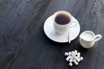 Cup of black tea with marshmallows cooked at home
