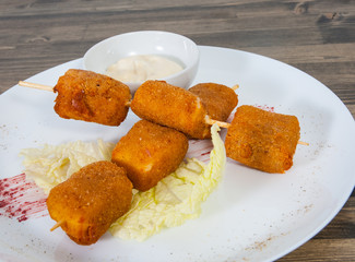 fried mozzarella cheese sticks breaded with sauce on plate