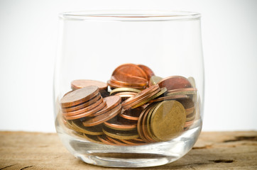 Fototapeta na wymiar Heap of coins in glass,saving money concept