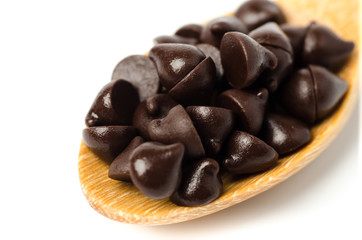 Chocolate chips on wooden spoon