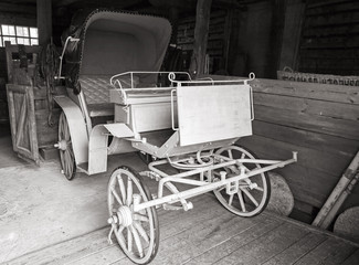 Fototapeta na wymiar Vintage coach stands in rural garage