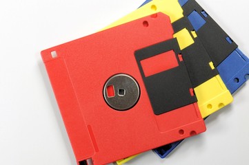Old color floppy disk. Red, yellow and blue.