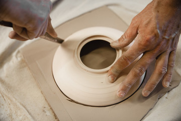 Potter master cutting the clay