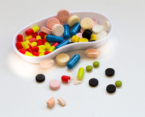 Medicine, pills of different colors on a white background, drugs health