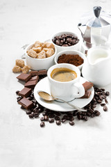 fresh coffee, chocolates and sweets on white background