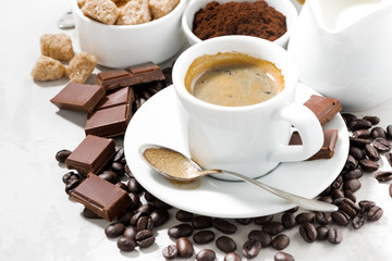 fresh coffee, chocolates and sweets on white table